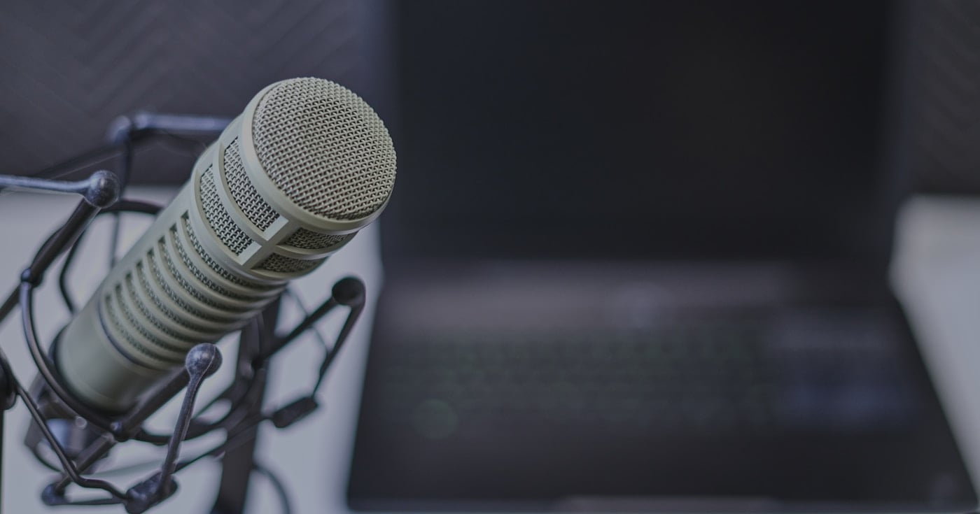 Gray condenser microphone near laptop for dictation