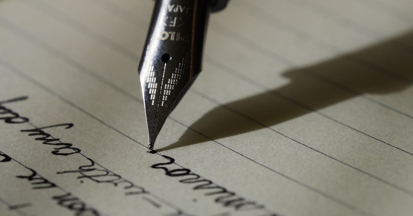 Copywriting definition — open notebook with pen and Storyteller sticker on a marble workspace