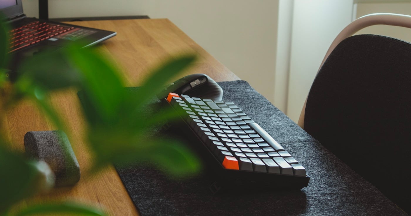 Writer at a minimal desk setup with keyboard