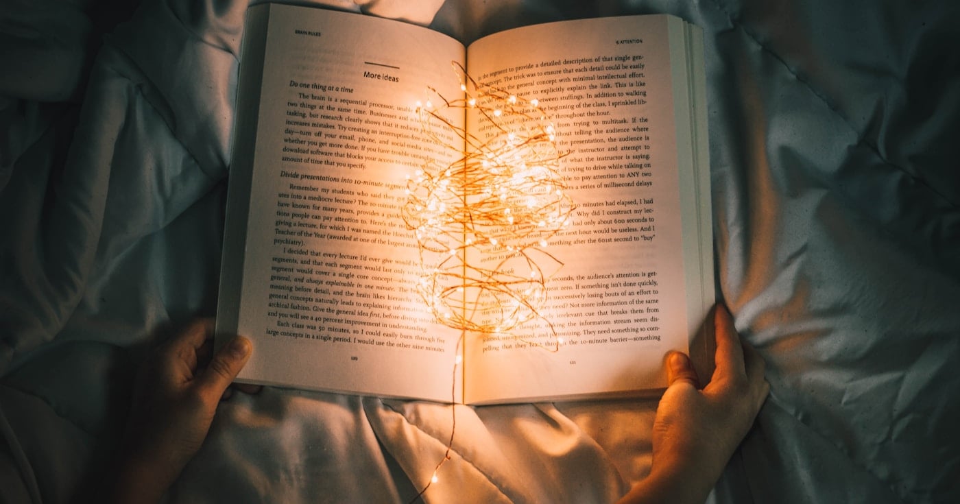 Open book in dark atmospheric light — foreshadowing in literature