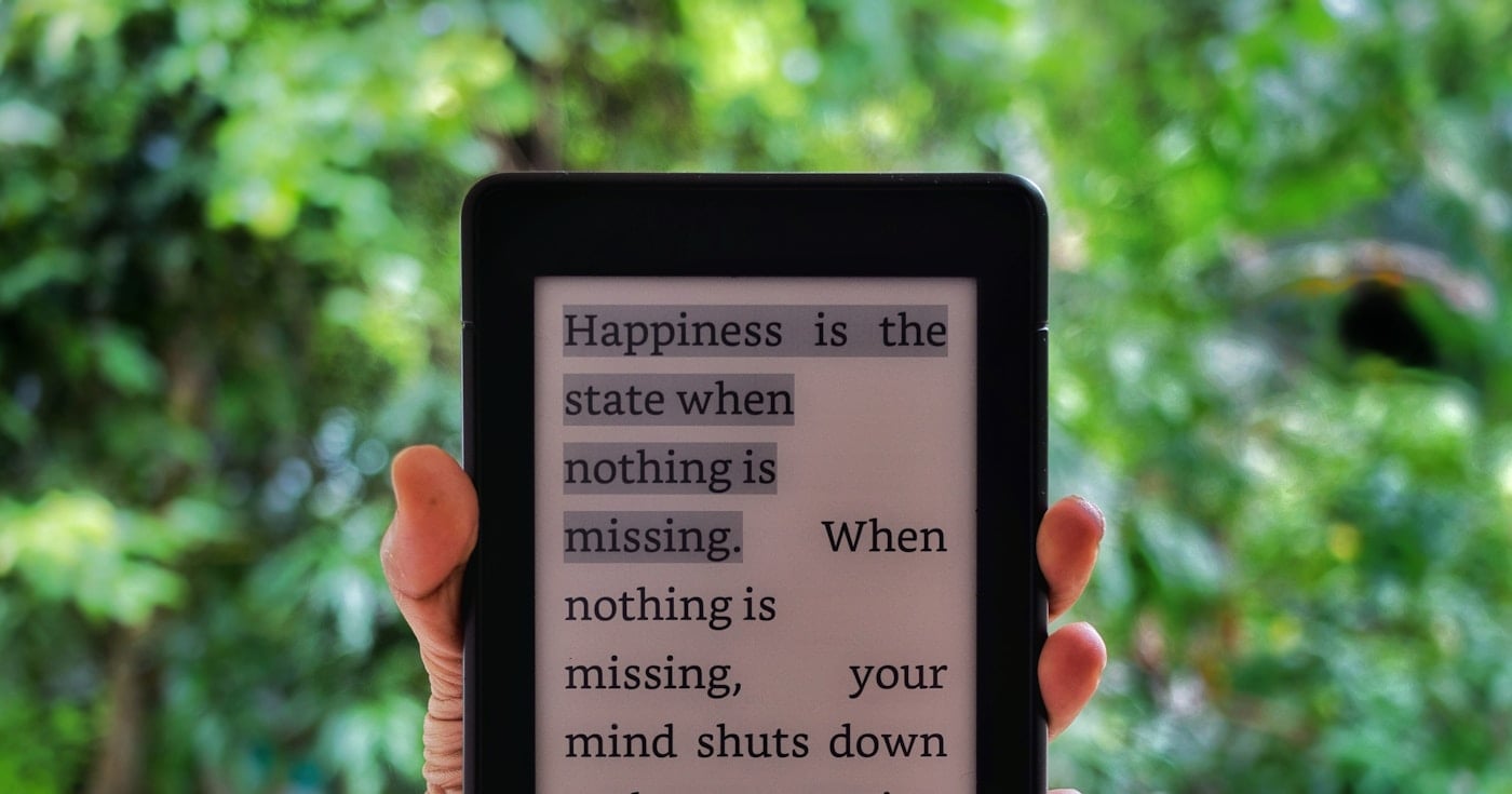 A Kindle e-reader held in hand, ready for reading