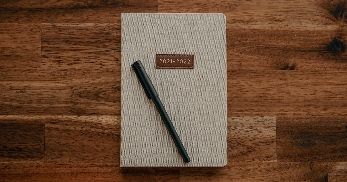 Writer journaling with pen and notebook