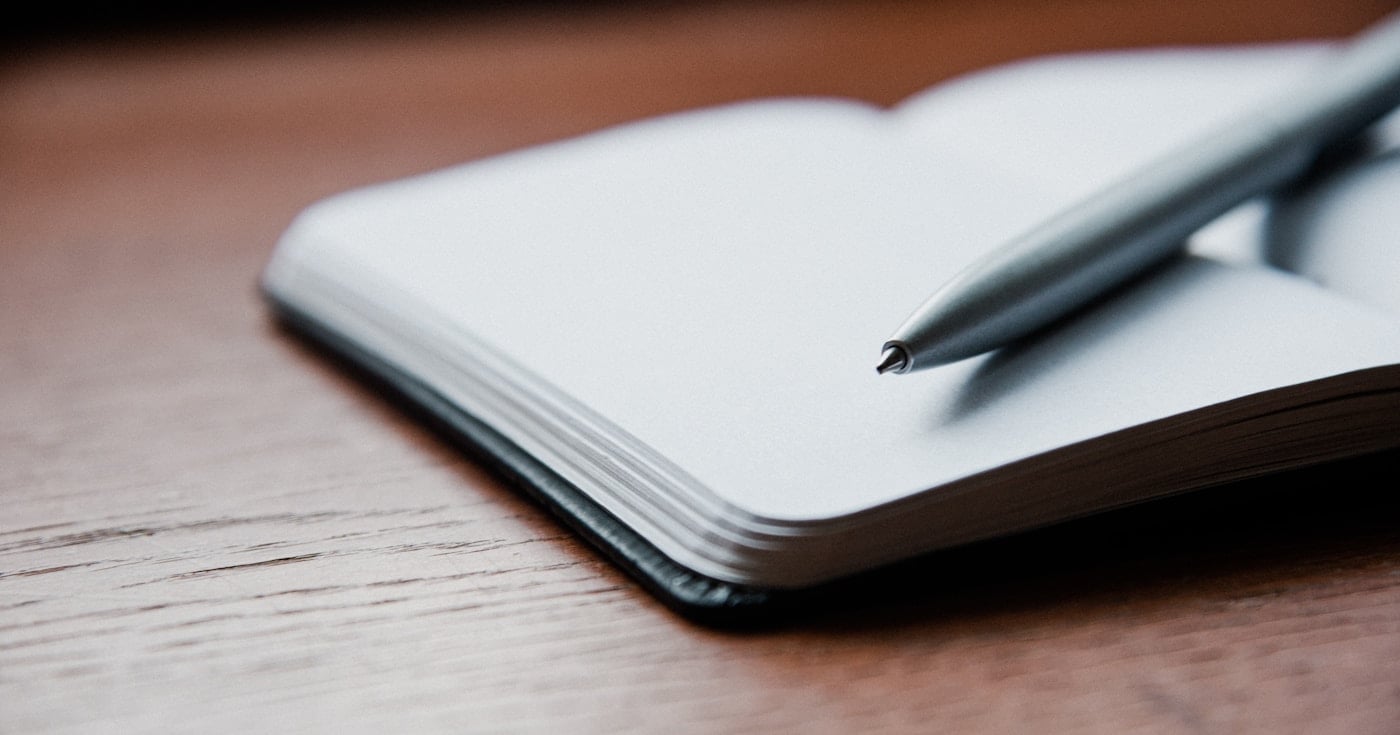 Notebook and pen on a clean desk — persuasive writing