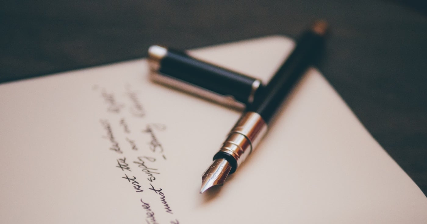Fountain pen on stationery representing the art of simile in writing