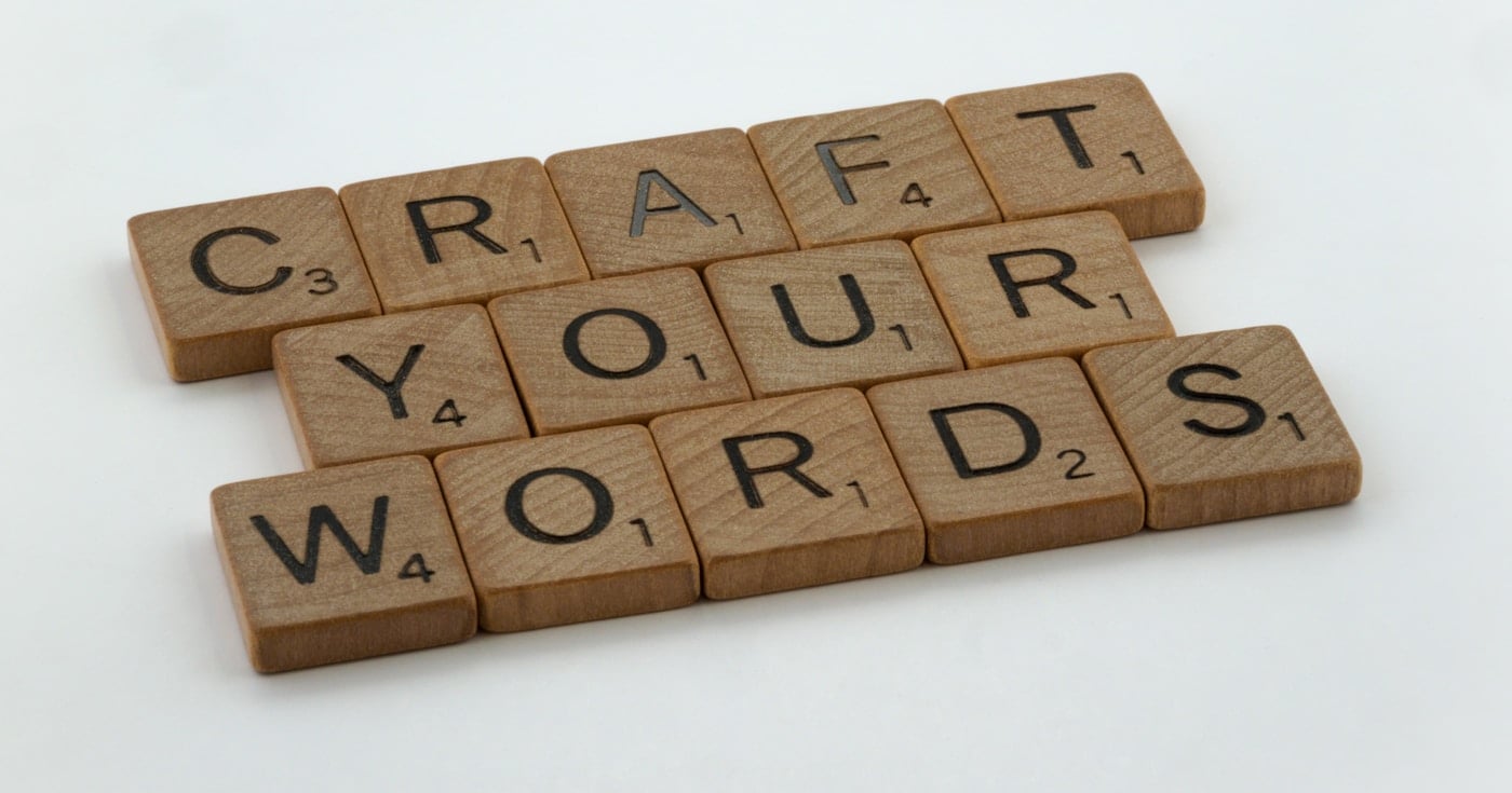 Scrabble tiles spelling out words, representing syntax and word arrangement in writing