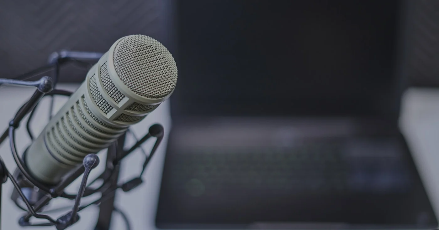 Gray condenser microphone near laptop for dictation