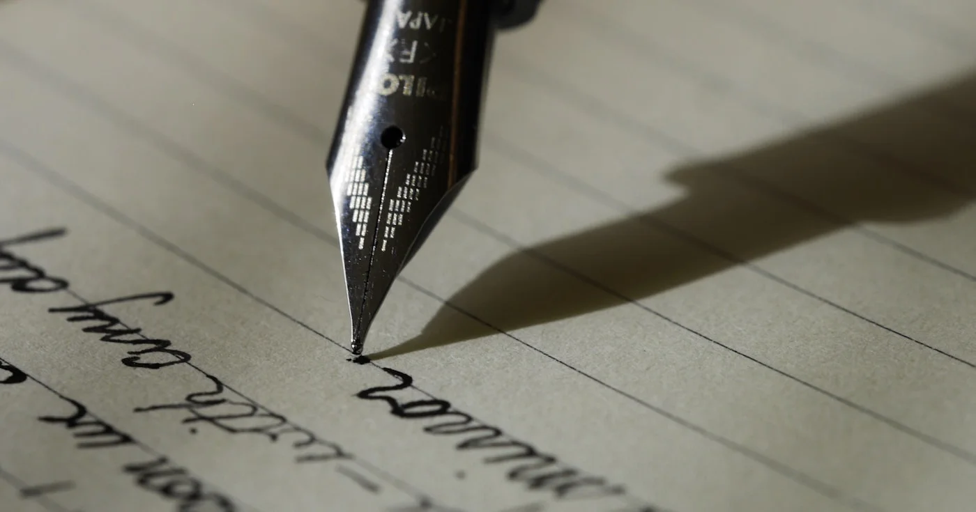 Copywriting definition — open notebook with pen and Storyteller sticker on a marble workspace