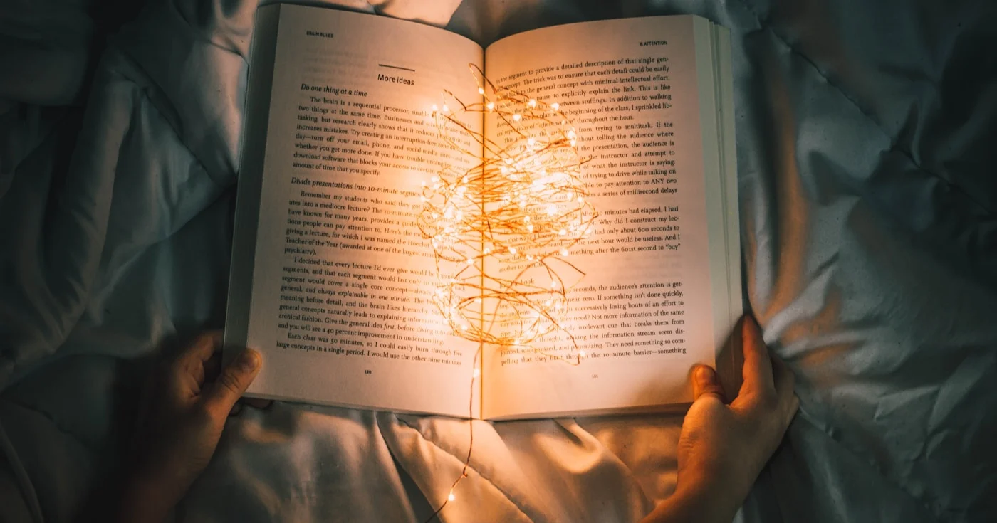 Open book in dark atmospheric light — foreshadowing in literature
