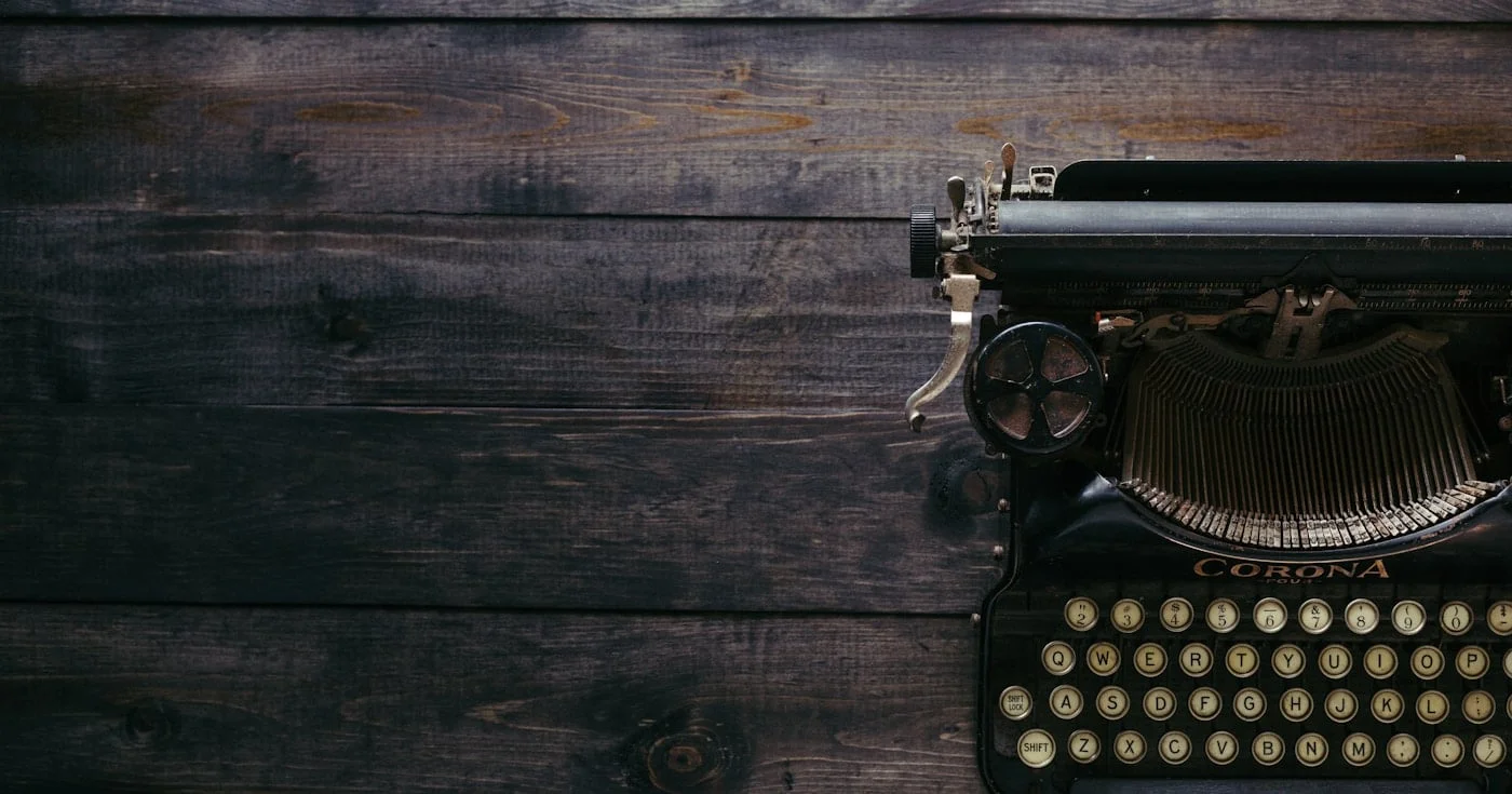 Antique Corona typewriter on dark wood